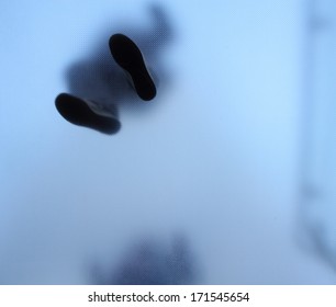 Feet Of People Who Standing On Translucent Glass