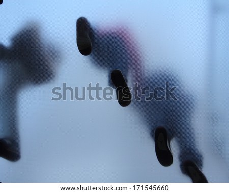 Feet of people who standing on translucent glass