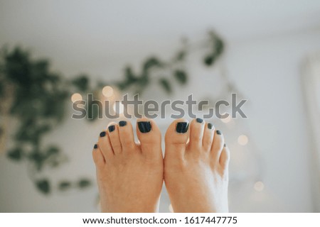 feet pic with greenery and lights 