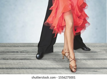 Feet Of Professional Tango Dancers In Dancing Movement On Bright Background Indoors