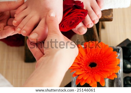 Feet receiving a massage sitting on a footstool