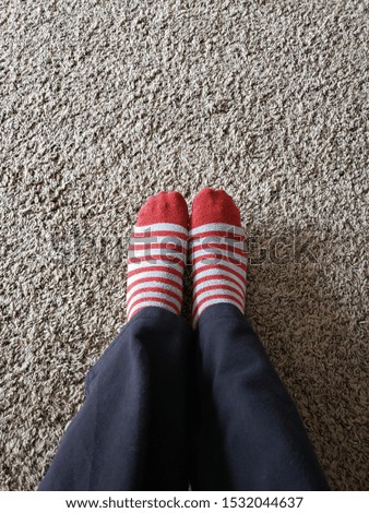 Feet in red/grey striped socks