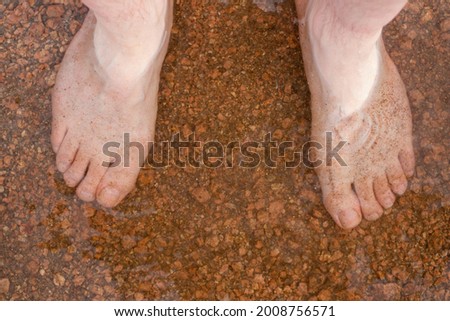 Feet in the rocky water