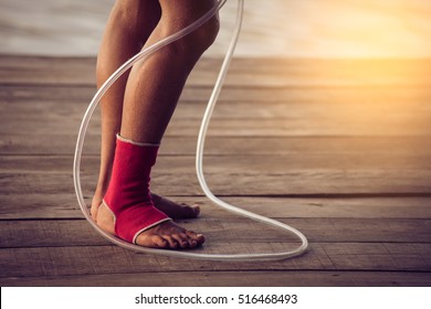 Feet Of Rope Jumping Man. Vintage Tinted Image