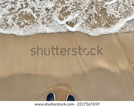 feet, sand and sea waves