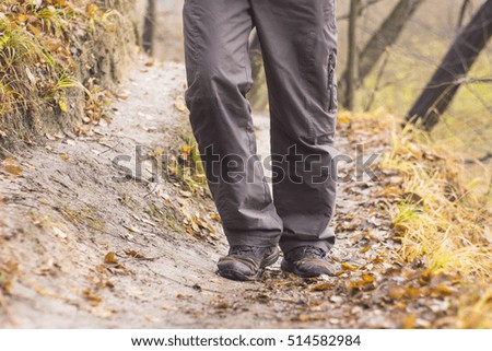 feet in shoes on a forest path