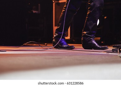 Feet of a singer at a concert, detail of a rock concert, party and music - Powered by Shutterstock