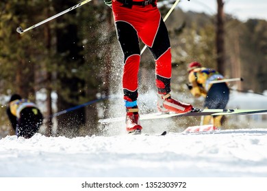 feet skier athlete rides on snow spray from under ski poles - Shutterstock ID 1352303972