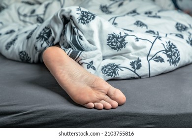 Feet Of A Sleeping Man, Relaxing In The Bed. Close Up Of Man's Feet.