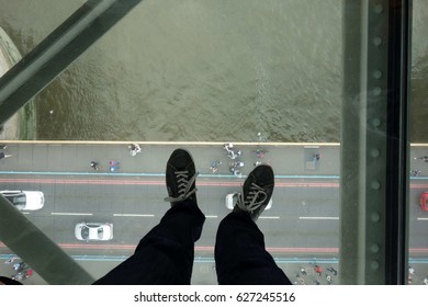 Feet Standing On The Glass Floor Up In The Tower Bridge, London, England