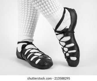 feet in traditional irish socks and shoes (pumps) on white background