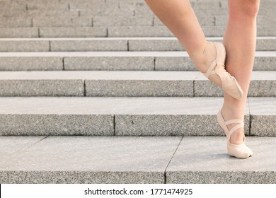 feet of an unrecognizable young ballet dancer on a stone staircase, dance concept and healthy lifestyle, copy space for text - Powered by Shutterstock