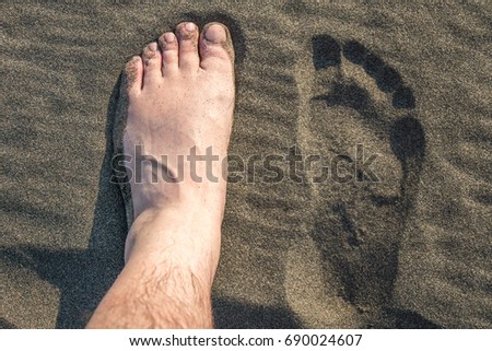 Feet in warm sand, Ureki beach, Georgia.