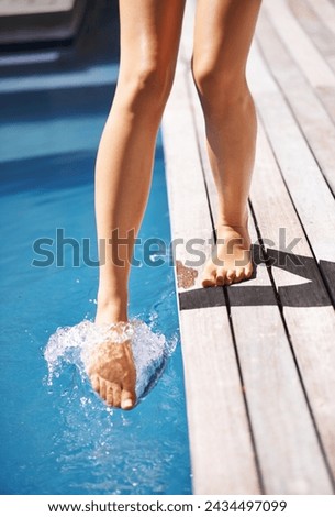 Feet, water and pool in splash, outdoor and backyard for summer day and relaxation to swim in heat. Toes, outside and wet in holiday, backyard and resort for fun in the sun on vacation at home