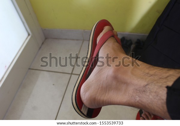 feet wearing sandal red\
colour