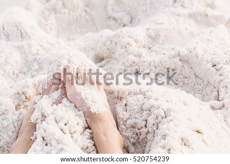 Feet in white sand with free space in film texture