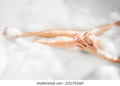 Feet of woman in bubble bath relaxing. Female Leg In Soapy Bath.  - Powered by Shutterstock