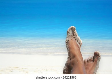 feet of a woman on a tropical beach