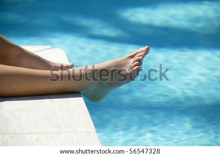 Feet of woman at a poolside