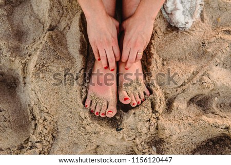 Feet of woman in the sand of a beach
