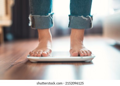 Feet Of Woman Standing On Electronic Scales For Weight Control, Female Checking BMI Weight Loss. Barefoot Measuring Body Fat Overweight.