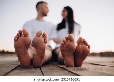 feet of a young couple on the background of the river - Powered by Shutterstock