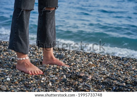 feet of a young woman on beach sand