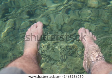 feets in the green water