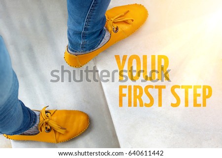 Feets in yellow shoes on stairs with inscription You first step