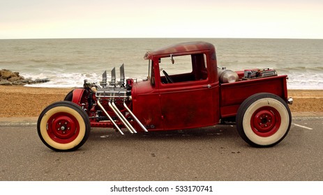 FELIXSTOWE, SUFFOLK, ENGLAND - AUGUST 27, 2016: Classic Hot Rod  pickup truck on seafront promenade with sea in background