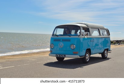 FELIXSTOWE, SUFFOLK, ENGLAND - MAY 01, 2016: Classic Blue and white VW camper van being driven along Felixstowe seafront promenade.