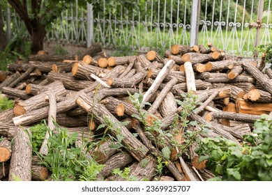 Felling a tree. Wooden logs from a pine forest, stacked in a forest. Forest of pine and spruce. Logging, logging, forest industry. Natural wood background. A pile of logs. Deforestation - Shutterstock ID 2369925707