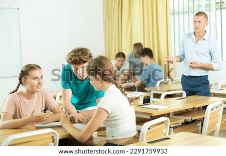 Fellow students having group work tasks during school day