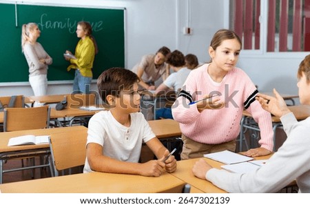 Fellow students having group work tasks during school day