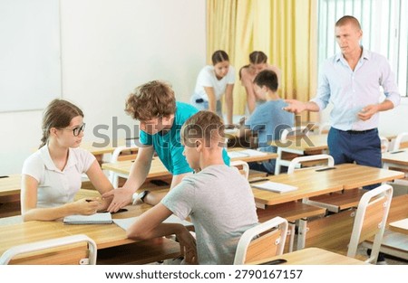 Fellow students having group work tasks during school day
