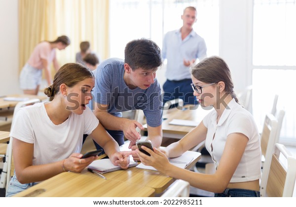 Fellow\
students having group work tasks during school\
day