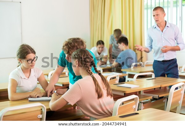 Fellow\
students having group work tasks during school\
day
