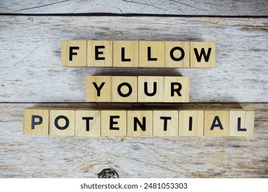 Fellow Your Potential with wooden blocks alphabet letterstop view on wooden background - Powered by Shutterstock