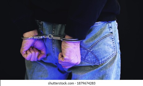 Felon in handcuffs with police strobe flashes