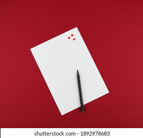 Felt Pen And Red Hearts On White Paper For Valentine Letter