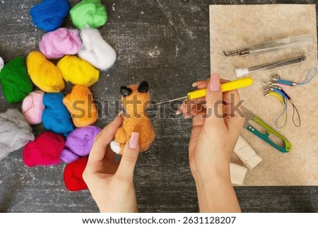 Felting process with wool and tools. Handmade wool toys in progress. Perfect for craft projects, DIY, needle felting, and creative textile work.