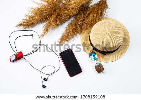 Female accessories lie collage with hat, watch, fashion glasses, mobile phone and earphones on a white background. Summer holidays, vacation, travel, travel concept