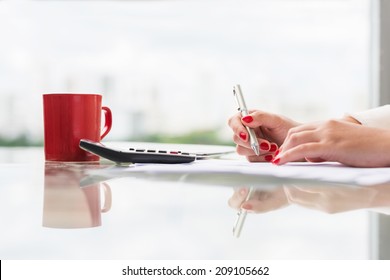 Female accountant signing a document, side view - Powered by Shutterstock