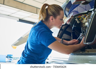 Female Aero Engineer Working On Helicopter In Hangar - Powered by Shutterstock