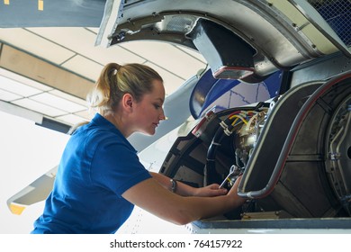 Female Aero Engineer Working On Helicopter In Hangar - Powered by Shutterstock