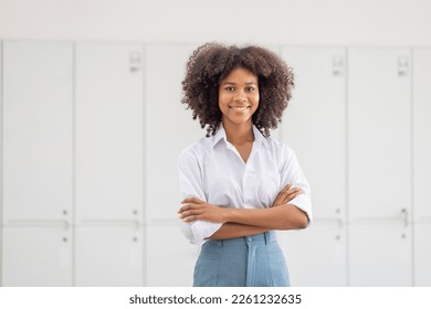 Female african american business woman in at the workplace, standing confidently. Attractive young businesswoman with a happy smile. - Powered by Shutterstock