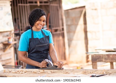 Female African Carpenter Smiling While Working