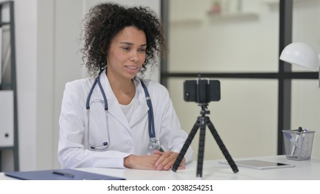 Female African Doctor Recording Video On Smartphone