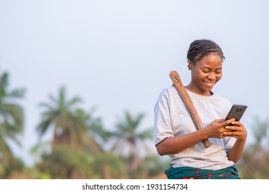 Female African Farmer Using Her Phone