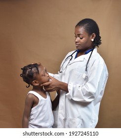 A Female African Nigerian Nurse Doctor Doing Medical Check Up For A Little Girl 